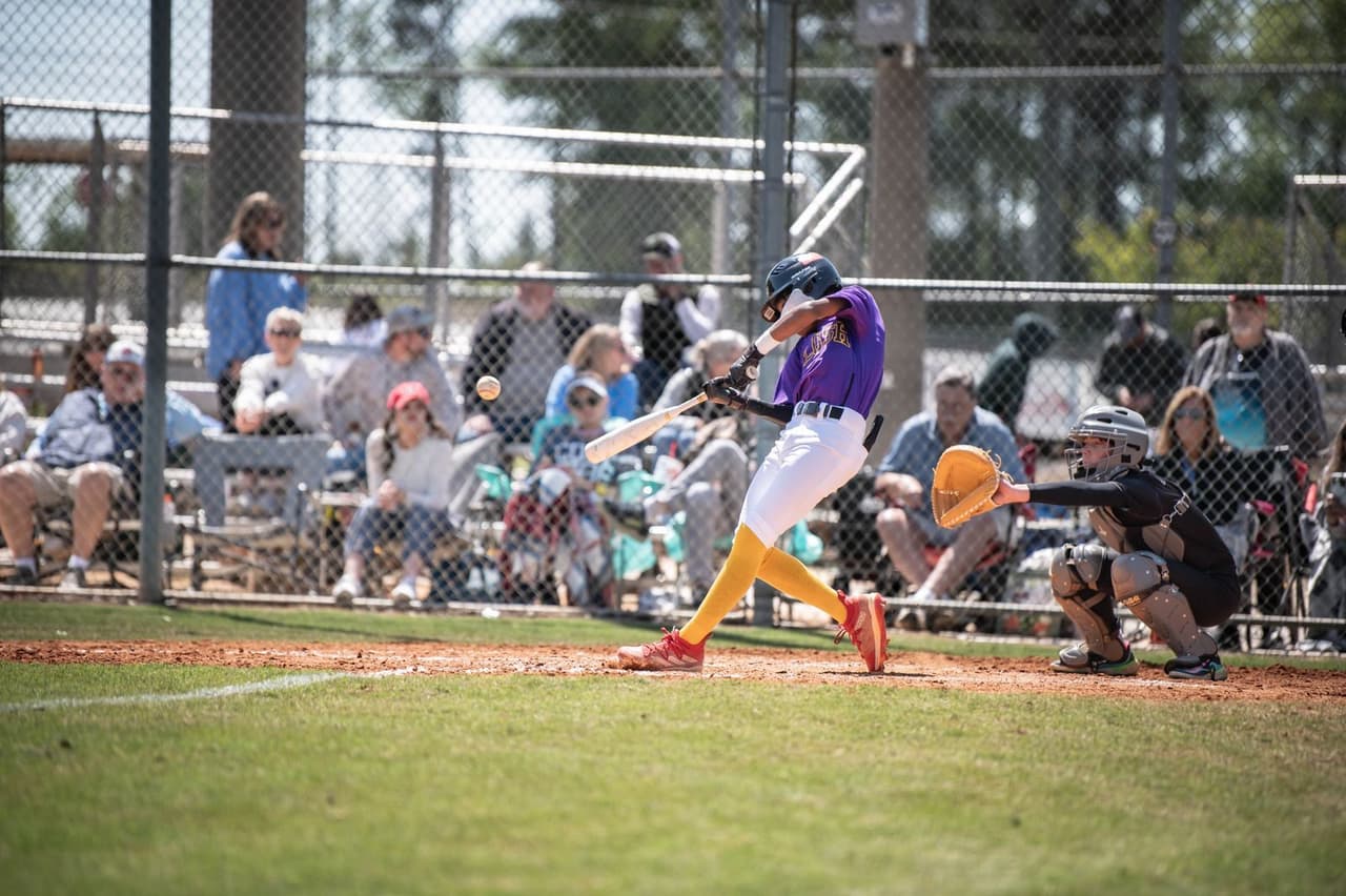 Youth baseball player working on his swing during a hitting drill