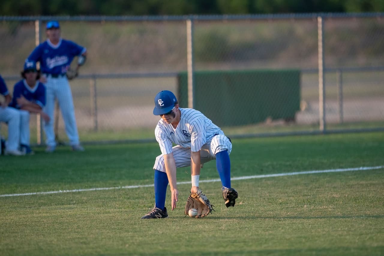 Youth baseball player fielding a ground ball during a defensive drill