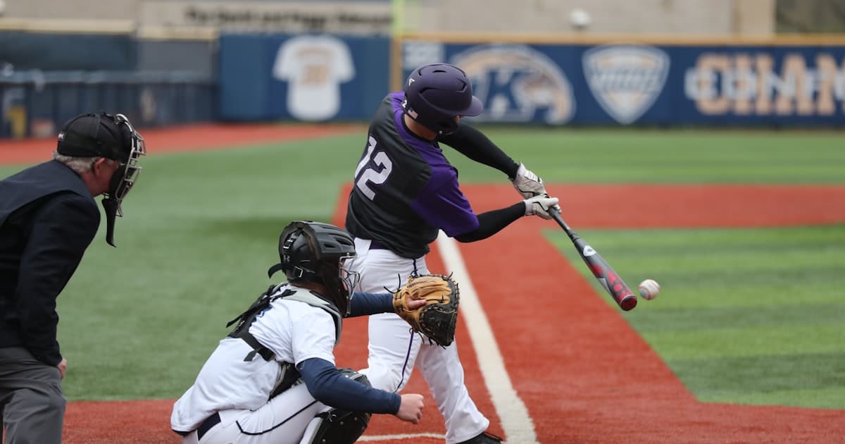 Youth baseball tournament game in progress with teams competing on a well-maintained field