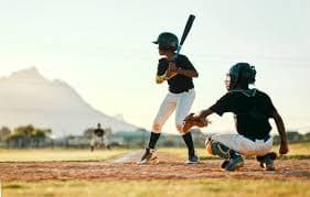 Youth baseball player at the plate making contact, illustrating the importance of finding the sweet spot and barrel contact