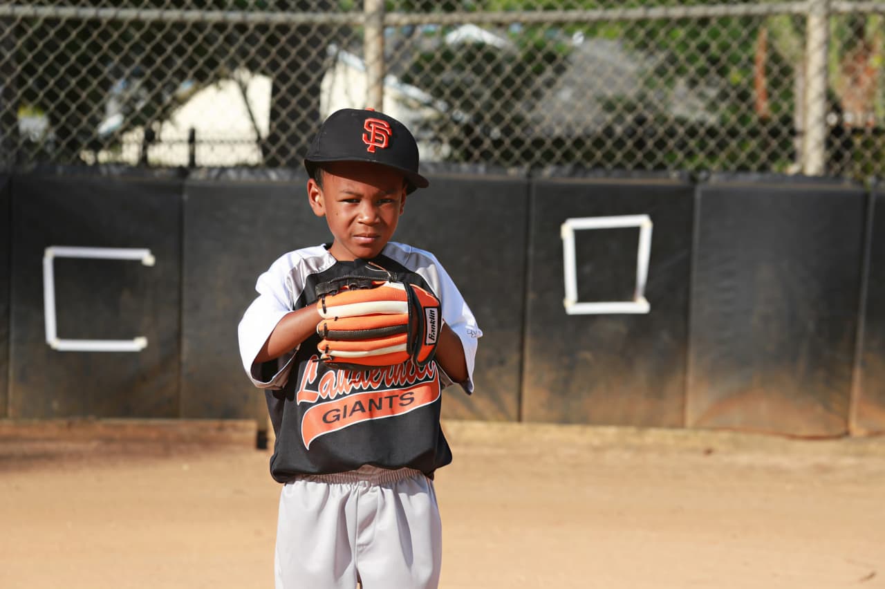 Youth baseball coach creating a fair lineup with equal playing time for all players
