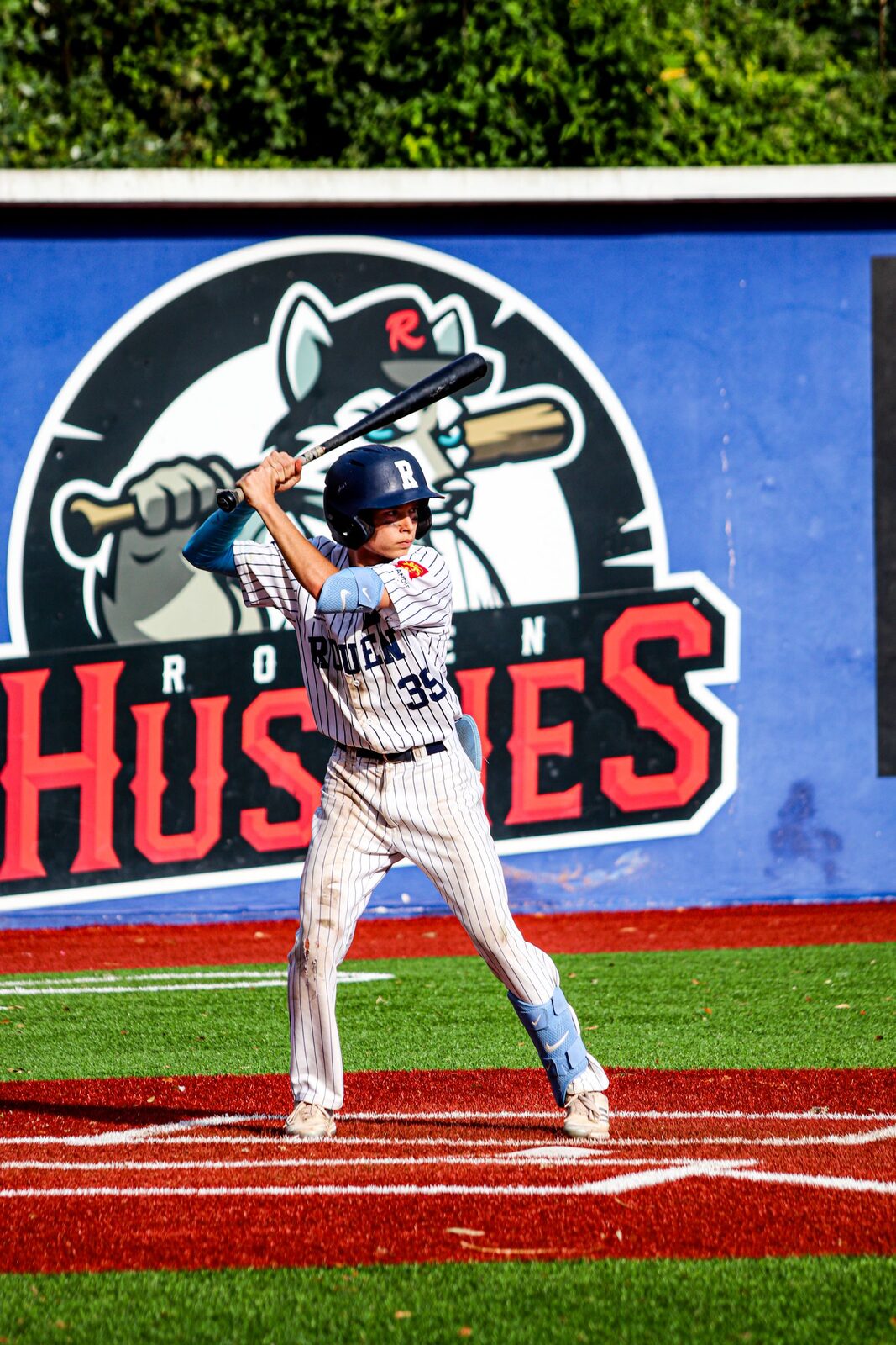 Youth baseball player holding a bat to check length and fit
