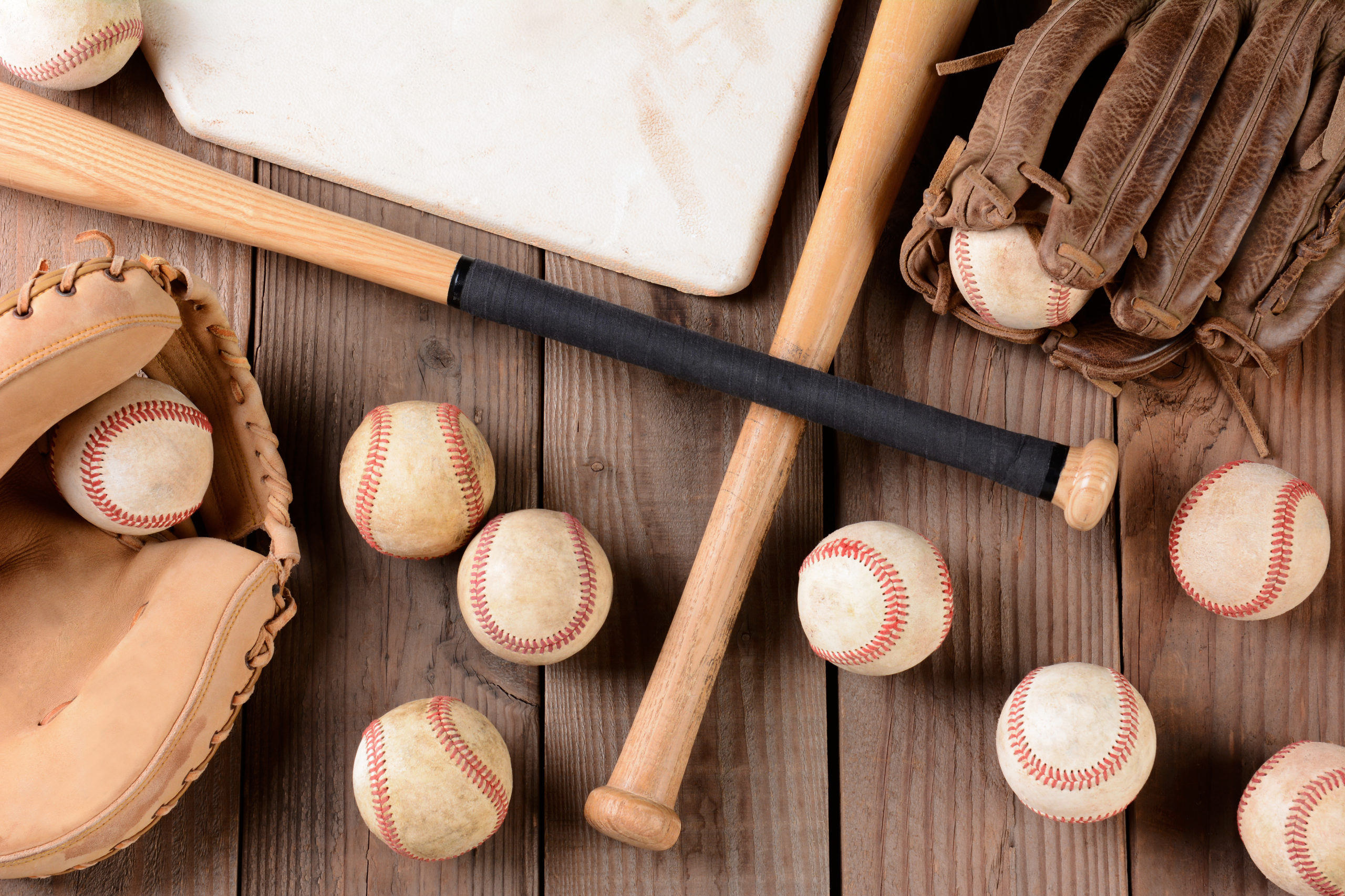 Basic youth baseball gear needed for a first-time coach: balls, gloves, tees, cones, bucket, first aid kit