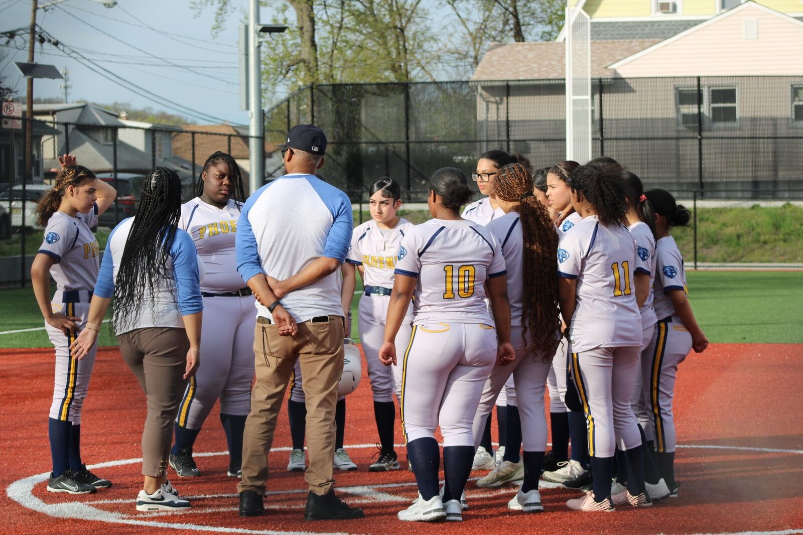 Coach talking to his team gathered around him on the field