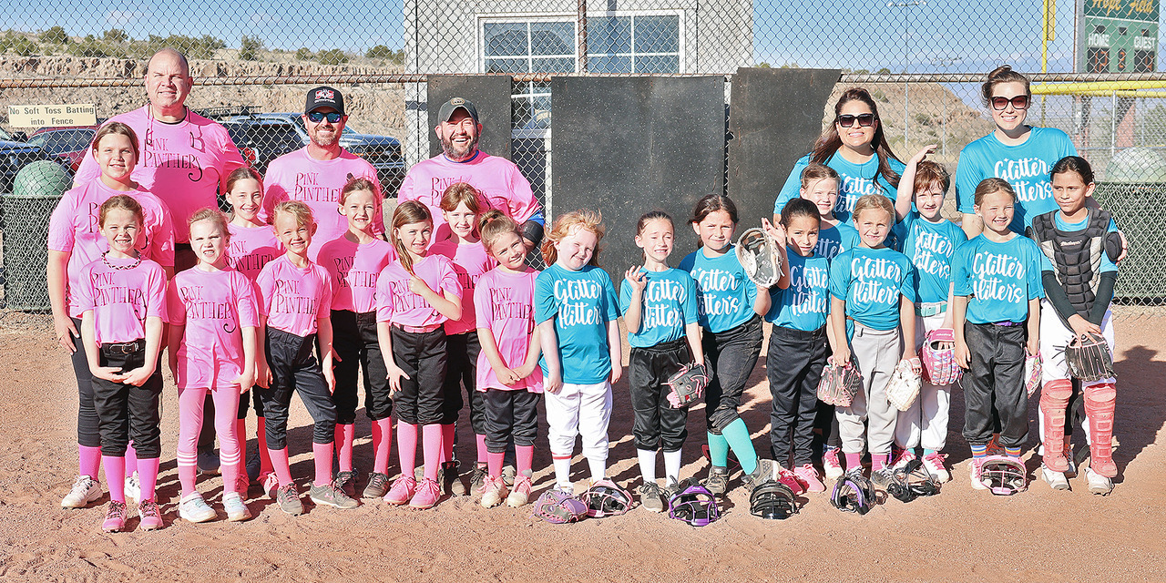 Youth softball coach working with team during practice session