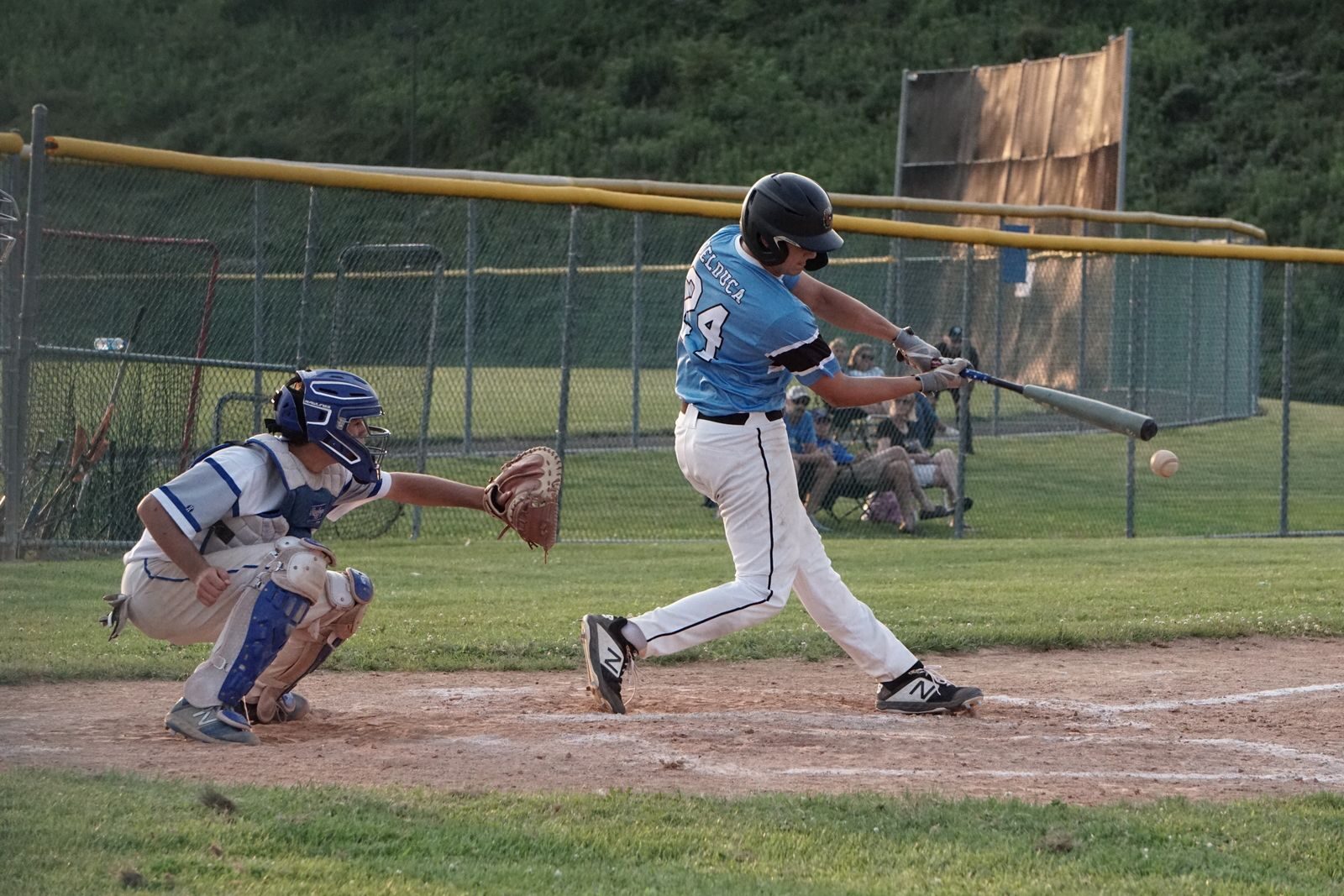 Developing high school hitter finishing a swing during batting practice