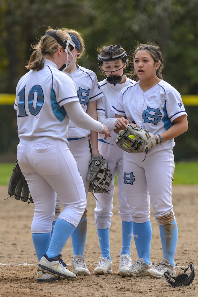 Youth softball team doing dynamic warmup drills together on the field before a game