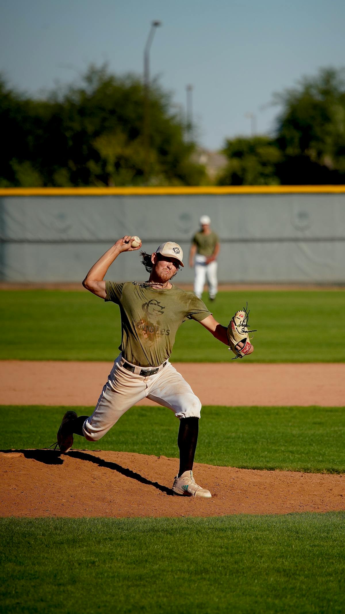 Baseball catcher framing a pitch at the edge of the strike zone behind home plate