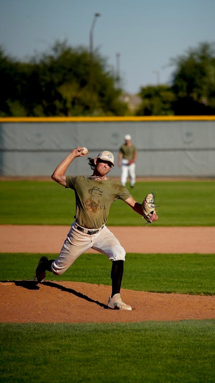 Middle infielder turning a double play with a throw to first base during a baseball game
