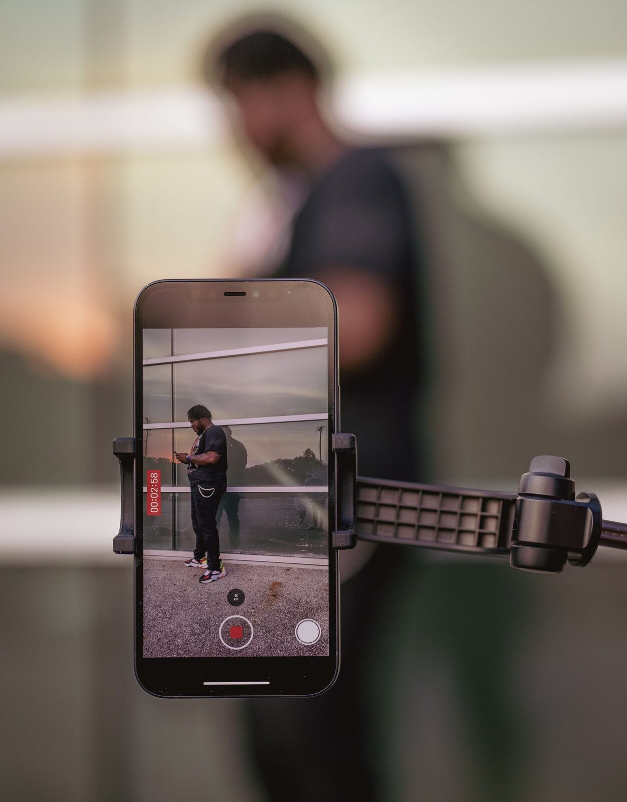 Smartphone mounted on a tripod recording a game