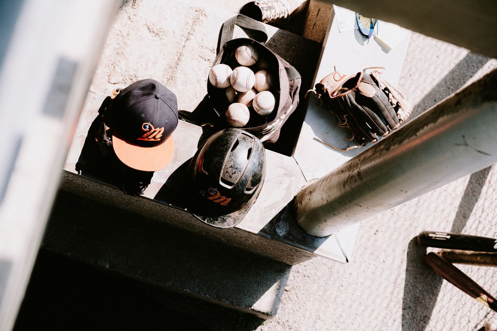 Helmets, balls and a glove racked in the dugout before a game