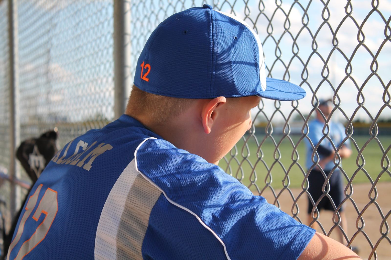 Watching a game from behind the chain-link backstop